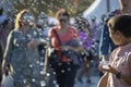 Istanbul, Turkey - September-28,2019: Child selling bubble machine on the street and little soap bubbles around. Blurred people