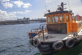 Istanbul, Turkey - September-28,2019: Closeup of fishing boat on hand. Galata bridge and sky in background