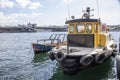 Istanbul, Turkey - September-28,2019: Closeup of fishing boat on hand. Galata bridge and sky in background