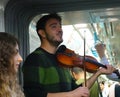 Istanbul, Turkey, September 22., 2018: Student playing the violin in the subway and singing a song.