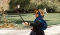 Istanbul, Turkey, September 2018: Young slightly overweight Asian woman with straw hat and sunglasses smilingly makes a selfie in