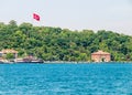 Istanbul / Turkey - Turkish flag, ship and residential buildings at Bosporus strait coast. Photo taken from cruise ship