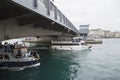 ISTANBUL / TURKEY - 30/05/2015: two tourist boats full of people navigating on the Bosporus under the Galata bridge with the Royalty Free Stock Photo