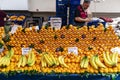 Istanbul Turkey 11/19/2019 View of a Turkish market vendor with his stall full of nicely stacked oranges and bananas.