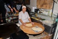 Istanbul, Turkish, 20.12.2019: Old woman making bread or gozleme, traditional baking