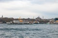 Istanbul view. Ferries and Hagia Sophia with cloudy sky