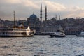 Istanbul view. A ferry and Eminonu Yeni Cami or New Mosque.