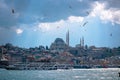 Istanbul view. Suleymaniye Mosque and boats with seagulls and partly cloudy sky. Royalty Free Stock Photo