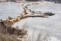 Isthmus in frozen water in a sandy quarry in the winter. Winter landscape