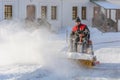 ISTRA, RUSSIA - FEBRUARY 05, 2021: Man with sweeping machine removing snow