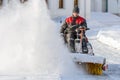 ISTRA, RUSSIA - FEBRUARY 05, 2021: Man with sweeping machine removing snow