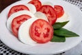 Itaian vegetarian food, fresh caprese salad made with white soft italian mozzarella cheese, red tomato and green basil with olive Royalty Free Stock Photo