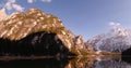 Italian Alps, Dolomiti. Mountain snowy peaks on the Braise lake. Timelapse with moving clouds.