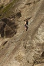 Italian alps - june 2020: a climber clinging to a spur of rock looks beneath him