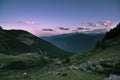 The Italian Alps at sunset. Summer colorful sky over the majestic mountain peaks, woodland and green valleys. Royalty Free Stock Photo