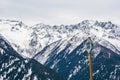 Italian Alps, Tourist sign snowshoes, snow rackets. Snow-capped mountains at the background.