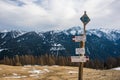 Italian Alps, Tourist signs - directions and snowshoes, snow rackets. Snow-capped mountains at the background.