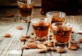 Italian amaretto liqueur with dry almonds on the old wooden back Royalty Free Stock Photo