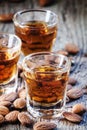 Italian amaretto liqueur with dry almonds on the old wooden back Royalty Free Stock Photo