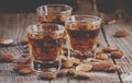 Italian amaretto liqueur with dry almonds on the old wooden back Royalty Free Stock Photo