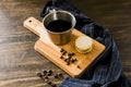 Italian american black coffee in a vintage cup with coffee beans around and a handmade cookie with sugar and a moka pot behind. Royalty Free Stock Photo