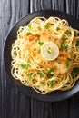 Italian-American cuisine chicken Francaise served with spaghetti with lemon sauce close-up on a plate. Vertical top view