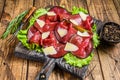 Italian Antipasti Bresaola meat cut with green salad and Parmesan. wooden background. Top view Royalty Free Stock Photo