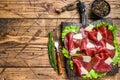 Italian Antipasti Bresaola meat cut with green salad and Parmesan. wooden background. Top view. Copy space Royalty Free Stock Photo