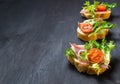 Italian antipasti crostini with ham, salad and tomato Royalty Free Stock Photo