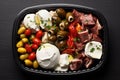 Italian Antipasti Set with Small Peppers Stuffed with Cream Cheese, Pickled Olives, Marinated Mushrooms