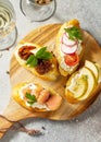 Italian Antipasti snacks set for Wine. Brushetta with Soft Cheese, Pear, Radish, Salmon and Dried Tomatoes Royalty Free Stock Photo