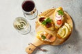 Italian Antipasti snacks set for Wine. Brushetta with Soft Cheese, Pear, Radish, Salmon and Dried Tomatoes Royalty Free Stock Photo