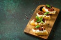 Italian Antipasti snacks for Wine. Brushetta with Soft Cheese and Dried Tomatoes served Royalty Free Stock Photo