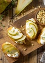 Italian Antipasti snacks for Wine. Brushetta with Soft Cheese, Pear and Pine Nuts