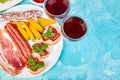 Italian antipasti wine snacks set. Brushettas on blue background