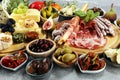 Italian antipasti wine snacks set. Cheese variety, Mediterranean olives, crudo, Prosciutto di Parma, salami and wine in glasses Royalty Free Stock Photo