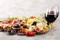 Italian antipasti wine snacks set. Cheese variety, Mediterranean olives, crudo, Prosciutto di Parma, salami and wine in glasses Royalty Free Stock Photo