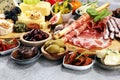 Italian antipasti wine snacks set. Cheese variety, Mediterranean olives, crudo, Prosciutto di Parma, salami and wine in glasses Royalty Free Stock Photo