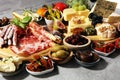 Italian antipasti wine snacks set. Cheese variety, Mediterranean olives, crudo, Prosciutto di Parma, salami and wine in glasses Royalty Free Stock Photo