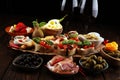 Italian antipasti wine snacks set. Cheese variety, Mediterranean olives, pickles, Prosciutto di Parma, tomatoes, artichokes and Royalty Free Stock Photo