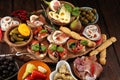 Italian antipasti wine snacks set. Cheese variety, Mediterranean olives, pickles, Prosciutto di Parma, tomatoes, artichokes Royalty Free Stock Photo