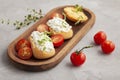 Italian appetizer toasted bread bruschetta with cream chease and tomatoes