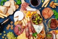 Italian appetizers or antipasto set with gourmet food on kitchen table top view. Mixed delicatessen of cheese and meat snacks