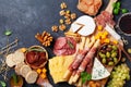 Italian appetizers or antipasto set with gourmet food on kitchen table top view. Mixed delicatessen of cheese and meat snacks Royalty Free Stock Photo