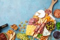Italian appetizers or antipasto set with gourmet food on table top view. Mixed delicatessen of cheese and meat snacks with wine Royalty Free Stock Photo