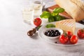 Italian appetizers, view from above - bread ciabatta, olives, tomatoes, cheese, pepper, fresh basil and wine Royalty Free Stock Photo