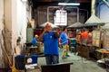 Venice, italy - 20 january 2020: italian artisan glassworker blowing hot glass with traditional, blowpipe in an italian glass Royalty Free Stock Photo