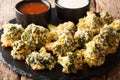 Italian baked broccoli appetizer with parmesan served with sauces. horizontal