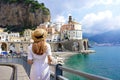 Italian Beauty Scenery. Back view of young woman with straw hat and white dress walking to Atrani village, Amalfi Coast, Italy Royalty Free Stock Photo