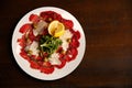 Italian beef carpaccio with parmesan shavings and rocket isolate